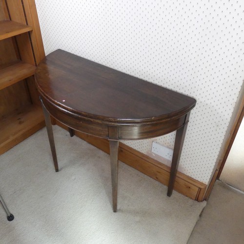 482 - A Georgian mahogany demi-lune card Table, folding top raised on four tapering supports, W 97 cm x H ... 