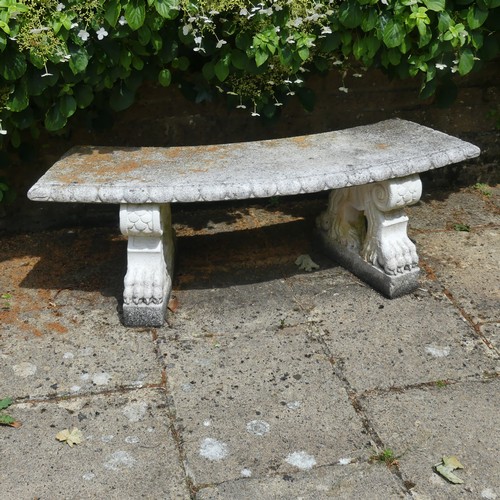 488 - A reconstituted stone garden Seat, of curved form raised on plinths, note split to underside, which ... 