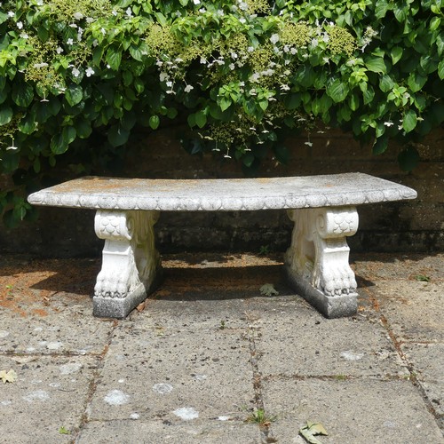 488 - A reconstituted stone garden Seat, of curved form raised on plinths, note split to underside, which ... 