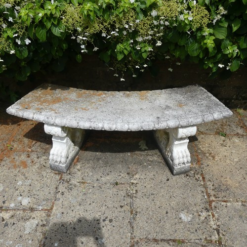 488 - A reconstituted stone garden Seat, of curved form raised on plinths, note split to underside, which ... 