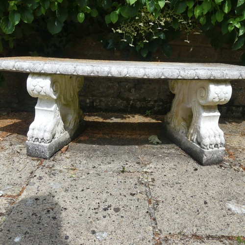 488 - A reconstituted stone garden Seat, of curved form raised on plinths, note split to underside, which ... 