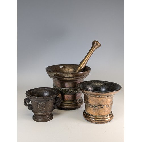 494 - A large 18th century bronze Mortar, with associated pestle, decorated with band of shells and scroll... 