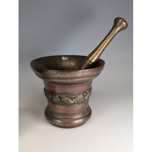 494 - A large 18th century bronze Mortar, with associated pestle, decorated with band of shells and scroll... 