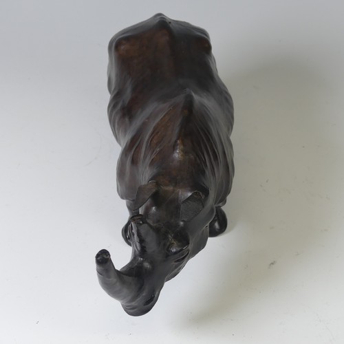 506 - In the manner of Liberty a leather model of a Rhino, with glass eyes, W 33 cm x H 14 cm x D 10 cm.... 