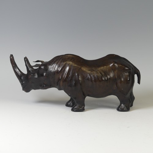 506 - In the manner of Liberty a leather model of a Rhino, with glass eyes, W 33 cm x H 14 cm x D 10 cm.... 