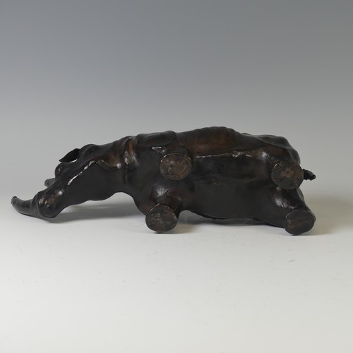 506 - In the manner of Liberty a leather model of a Rhino, with glass eyes, W 33 cm x H 14 cm x D 10 cm.... 