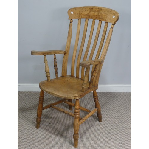 508 - A late 19th century ash and elm Windsor Armchair, shaped headrest over stick-back, raised on scrolle... 