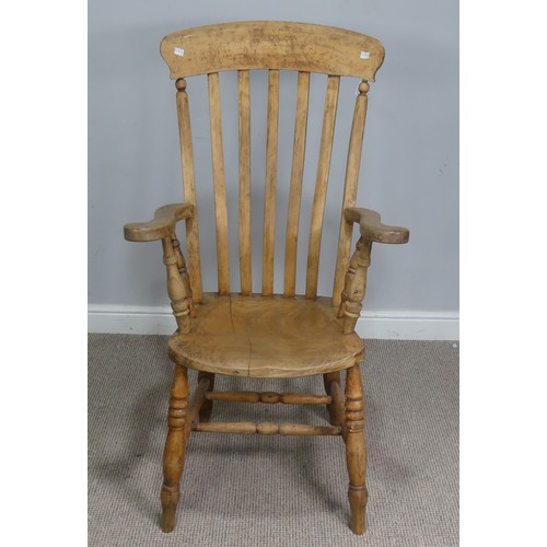 508 - A late 19th century ash and elm Windsor Armchair, shaped headrest over stick-back, raised on scrolle... 