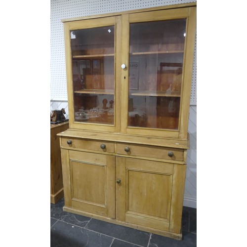 511 - An early 20th century pine kitchen Dresser, glazed cupboard doors concealing two shelves, raised on ... 