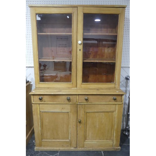 511 - An early 20th century pine kitchen Dresser, glazed cupboard doors concealing two shelves, raised on ... 