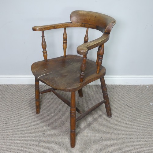 513 - An early 20th century ash and elms smokers bow Armchair, raised on turned supports, note, split to s... 