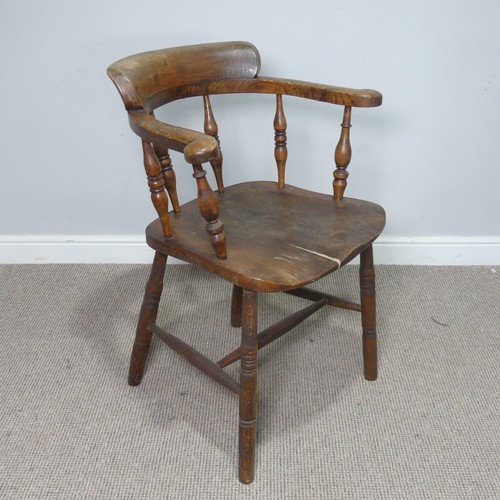 513 - An early 20th century ash and elms smokers bow Armchair, raised on turned supports, note, split to s... 