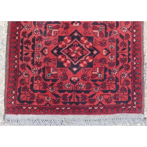 554 - Tribal Rugs: two small Afghan red-ground runners, both approx. 148cm x 52cm and in good condition (2... 