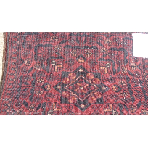 554 - Tribal Rugs: two small Afghan red-ground runners, both approx. 148cm x 52cm and in good condition (2... 