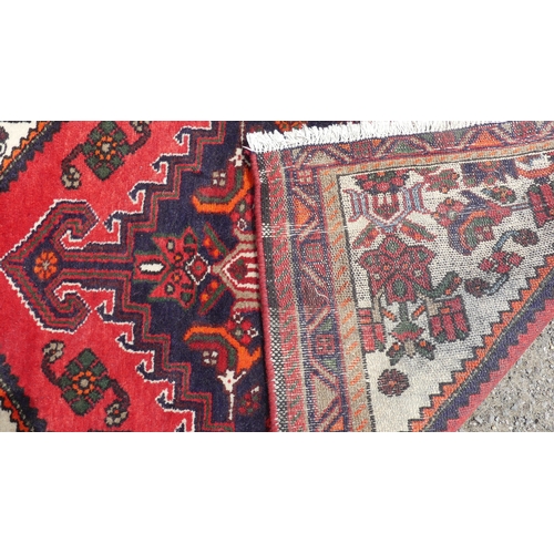 555 - Tribal Rugs: a Hamadan red-ground Rug, 147cm x 104cm, good condition, together with another similar,... 