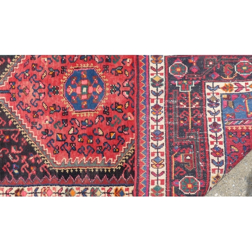 556 - Tribal Rugs; a Hamadan red-ground Rug, 171cm x 103cm, good condition.