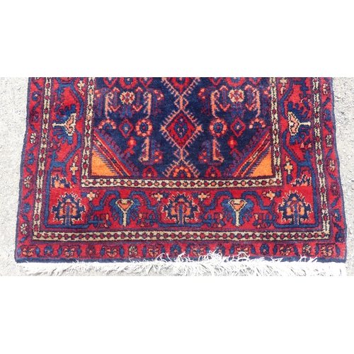 557 - Tribal Rugs; a Hamadan dark blue and red-ground Rug, 179cm x 112cm, fringes worn, pile in good condi... 