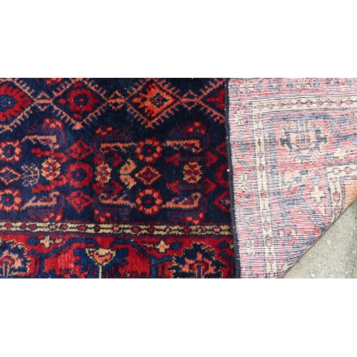 557 - Tribal Rugs; a Hamadan dark blue and red-ground Rug, 179cm x 112cm, fringes worn, pile in good condi... 