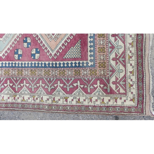 560 - Tribal Rugs; a hand-knotted Turkish pink and cream-ground Carpet, wool pile on wool base, 306cm x 23... 