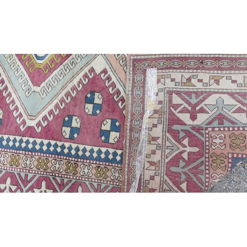 560 - Tribal Rugs; a hand-knotted Turkish pink and cream-ground Carpet, wool pile on wool base, 306cm x 23... 