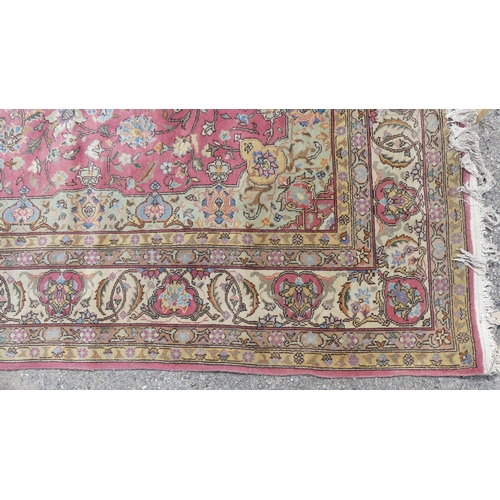 561 - Tribal rugs; a hand-knotted salmon-pink ground Persian carpet, wool pile on cotton base, with gold a... 