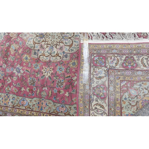 561 - Tribal rugs; a hand-knotted salmon-pink ground Persian carpet, wool pile on cotton base, with gold a... 