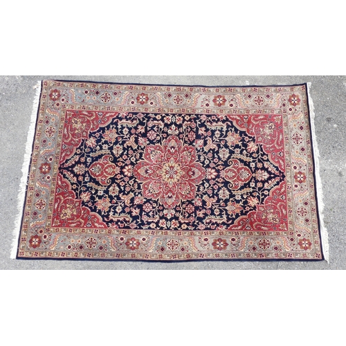 562 - Tribal rugs; a hand-knotted dark blue and salmon-pink ground Persian Rug, wool pile on cotton base, ... 