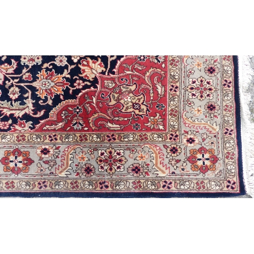 562 - Tribal rugs; a hand-knotted dark blue and salmon-pink ground Persian Rug, wool pile on cotton base, ... 