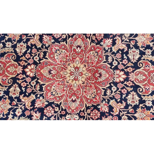 562 - Tribal rugs; a hand-knotted dark blue and salmon-pink ground Persian Rug, wool pile on cotton base, ... 