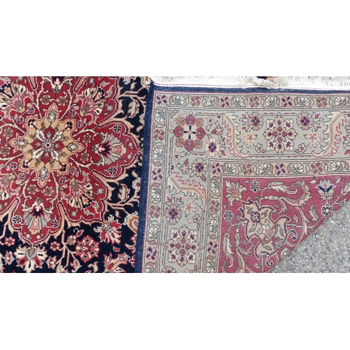 562 - Tribal rugs; a hand-knotted dark blue and salmon-pink ground Persian Rug, wool pile on cotton base, ... 