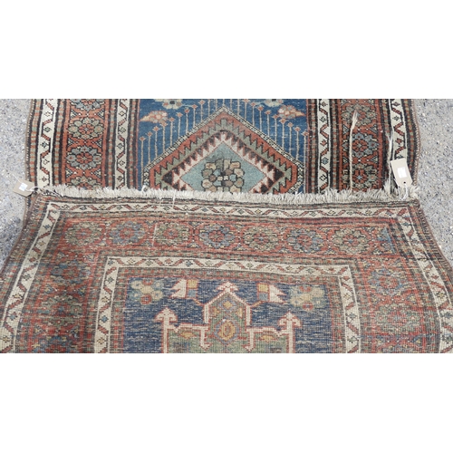 563 - Tribal rugs; a hand-knotted blue ground Caucasian Runner, wool pile on cotton and wool base, with da... 