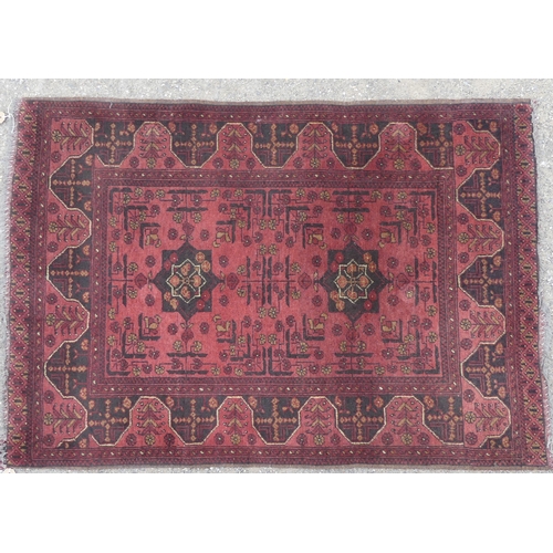 565 - Tribal rugs; a hand-knotted red- ground Afghan Rug, wool pile on wool base, 148cm x 102cm, fringes r... 