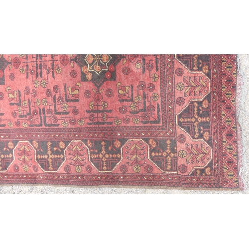 565 - Tribal rugs; a hand-knotted red- ground Afghan Rug, wool pile on wool base, 148cm x 102cm, fringes r... 