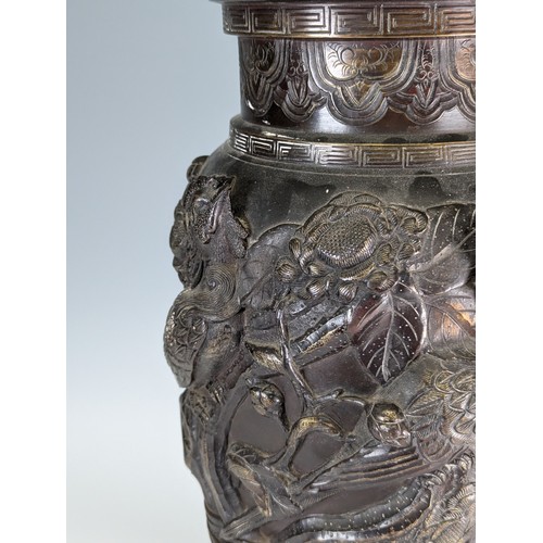 153 - A large Japanese Meiji Period bronze Vase (1868 - 1912), decorated in relief of stylised Peacocks an... 