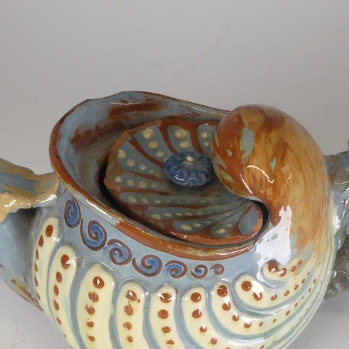 118 - A C H Brannam Barum pottery nautilus shape grotesque Teapot, with bird spout decorated in tones of b... 