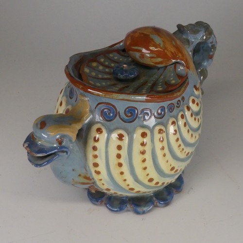 118 - A C H Brannam Barum pottery nautilus shape grotesque Teapot, with bird spout decorated in tones of b... 