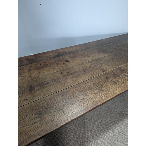 539 - A large 19th century farmhouse kitchen Table, four plank top with cleated ends, raised on later oak ... 