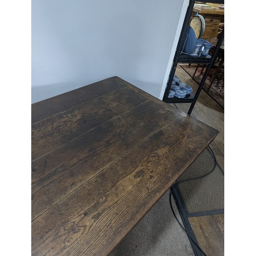 539 - A large 19th century farmhouse kitchen Table, four plank top with cleated ends, raised on later oak ... 