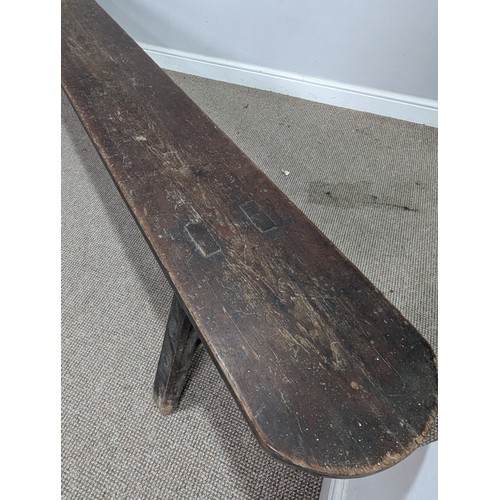 540 - A large 19th century pine joint Bench or Form, the rectangular top with rounded ends, raised on tres... 