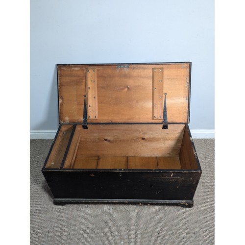 542 - An antique ebonised pine Trunk, with carrying handles to either side, W 105 cm x H 47 cm x D 48 cm.... 