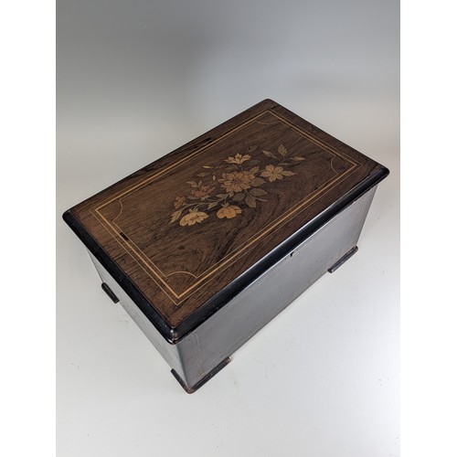 528 - A 19th century rosewood and marquetry musical Box, playing on eight airs and three bells, paper stam... 