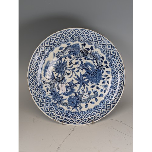 154 - A 19thC Chinese blue and white porcelain Plate, decorated in dragons, D 26cm, together with a Chines... 