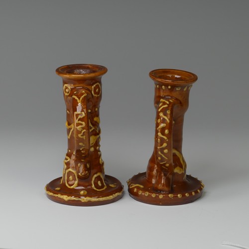 9 - Edwin Beer Fishley (1832-1912) two Fremington Pottery Candlesticks, in Wrotham style with brown grou... 