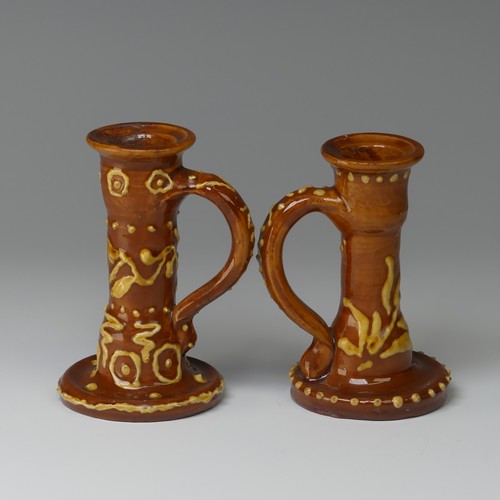 9 - Edwin Beer Fishley (1832-1912) two Fremington Pottery Candlesticks, in Wrotham style with brown grou... 