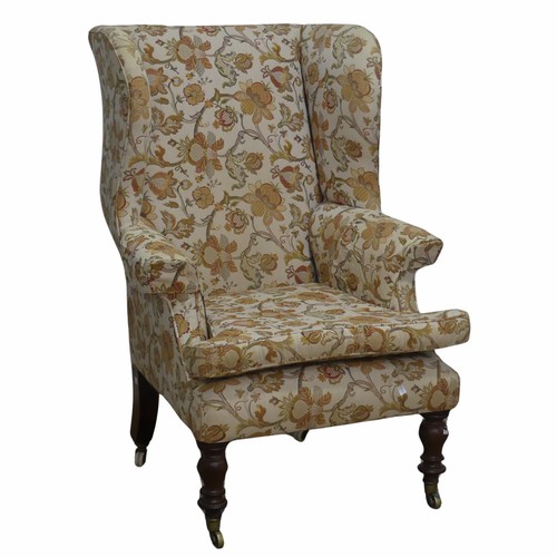 503 - A Victorian mahogany wing Armchair, the upholstered back with lugged sides and outscrolled arms, rai... 