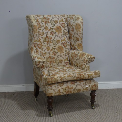 503 - A Victorian mahogany wing Armchair, the upholstered back with lugged sides and outscrolled arms, rai... 