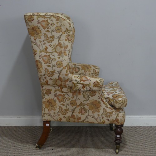 503 - A Victorian mahogany wing Armchair, the upholstered back with lugged sides and outscrolled arms, rai... 