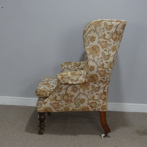 503 - A Victorian mahogany wing Armchair, the upholstered back with lugged sides and outscrolled arms, rai... 