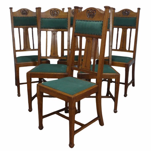 511 - A set of six oak Arts and Crafts dining Chairs, in the manner of Liberty, with carved and upholstere... 