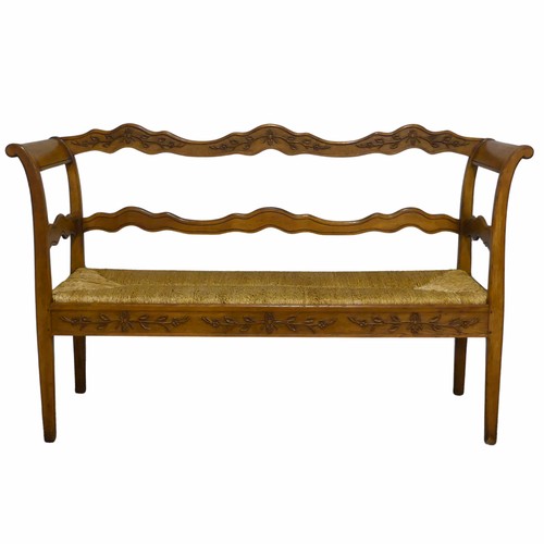 513 - A 20th century French oak and rush seat Bench/Sofa, with carved headrest and apron, flanked by scrol... 